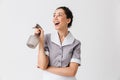 Portrait of a smiling young housemaid dressed in uniform Royalty Free Stock Photo