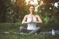 Outgoing woman making yoga on green grass Royalty Free Stock Photo