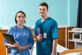 Portrait of smiling young male and female doctor in uniform with Royalty Free Stock Photo
