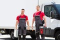 Portrait Of A Smiling Young Male Technicians Holding Tool Box