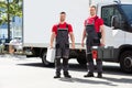 Portrait Of A Smiling Young Male Technicians Holding Tool Box Royalty Free Stock Photo