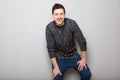 Smiling young man against gray background Royalty Free Stock Photo