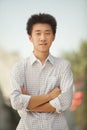 Portrait of Smiling Young Man with arms crossed in Nanluoguxiang, Beijing, China