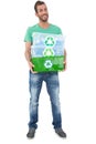 Portrait of a smiling young man carrying recycle containers