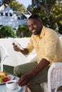 Portrait of smiling young man having coffee cup while holding digital tablet Royalty Free Stock Photo