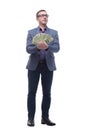 Portrait of smiling young man holding fanned US paper currency Royalty Free Stock Photo