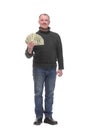 Portrait of smiling young man holding fanned US paper currency Royalty Free Stock Photo