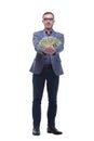 Portrait of smiling young man holding fanned US paper currency Royalty Free Stock Photo