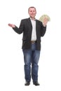 Portrait of smiling young man holding fanned US paper currency Royalty Free Stock Photo