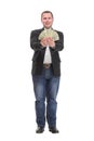 Portrait of smiling young man holding fanned US paper currency Royalty Free Stock Photo