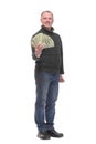 Portrait of smiling young man holding fanned US paper currency Royalty Free Stock Photo