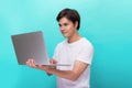 Portrait of smiling young man with laptop isolated on blue Royalty Free Stock Photo