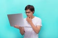 Portrait of smiling young man with laptop isolated on blue Royalty Free Stock Photo