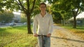 PORTRAIT: Smiling young man looks into the camera while riding an e-scooter. Royalty Free Stock Photo