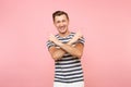 Portrait smiling young man in striped t-shirt pointing index fingers up on copy space, looking up isolated on trending Royalty Free Stock Photo