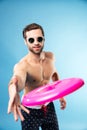 Portrait of a smiling young man throwing frisbee