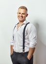 Portrait of smiling young man in white shirt and suspenders Royalty Free Stock Photo