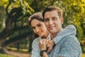 Portrait smiling young man and woman couple in love hugging in the park at summer season with warm sunlight. people and lifestyle Royalty Free Stock Photo