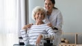Portrait of smiling young professional therapist with disabled patient. Royalty Free Stock Photo