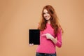 Portrait of a smiling young redhead girl pointing finger Royalty Free Stock Photo