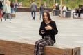 Portrait of a smiling young student woman near the university talking on a smartphone Royalty Free Stock Photo