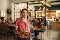 Group of young friends ordering food in a restaurant Royalty Free Stock Photo