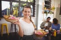 Portrait of smiling young waitress carrying food in wicker baskets Royalty Free Stock Photo