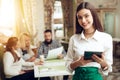 Portrait smiling young waitress standing in cafe Royalty Free Stock Photo