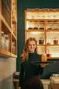 Smiling young waitress serving drinks in a trendy bar Royalty Free Stock Photo