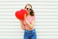 Portrait smiling young woman with air balloons heart shape having fun over white Royalty Free Stock Photo