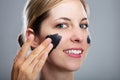 Woman Applying Activated Charcoal Mask On Her Face Royalty Free Stock Photo