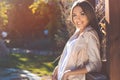 Portrait of smiling young woman, autumn time