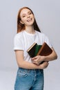 Portrait of smiling young woman college student holding books and looking at camera. Royalty Free Stock Photo