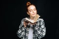 Portrait of smiling young woman college student standing with closed eyes holding opened book Royalty Free Stock Photo