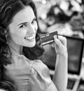 Smiling young woman with credit card using laptop in Royalty Free Stock Photo