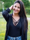 Portrait of smiling young woman with dark clothing