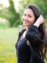 Portrait of smiling young woman with dark clothing