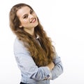 Portrait of smiling young woman dressed in a blue shirt on a white background in passive attitude