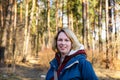 Portrait of a smiling young woman at the edge of the forest in early spring Royalty Free Stock Photo