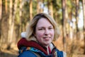 Portrait of a smiling young woman at the edge of the forest in early spring Royalty Free Stock Photo