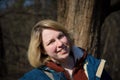 Portrait of a smiling young woman at the edge of the forest in early spring Royalty Free Stock Photo