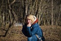 Portrait of a smiling young woman at the edge of the forest in early spring Royalty Free Stock Photo