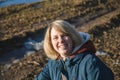 Portrait of a smiling young woman at the edge of the forest in early spring Royalty Free Stock Photo