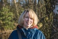 Portrait of a smiling young woman at the edge of the forest in early spring Royalty Free Stock Photo