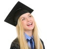 Portrait of smiling young woman in graduation gown looking on co Royalty Free Stock Photo