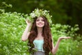 Portrait of smiling young woman in green spring park with open e Royalty Free Stock Photo