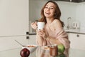 Portrait of a smiling young woman having healthy breakfast Royalty Free Stock Photo