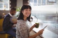 Portrait of smiling young woman holding drink and tablet Royalty Free Stock Photo