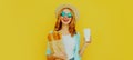 Portrait smiling young woman holding grocery shopping paper bag with long white bread baguette and coffee cup on a yellow Royalty Free Stock Photo