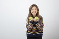 Portrait of a smiling young woman holding two fresh green apples Royalty Free Stock Photo